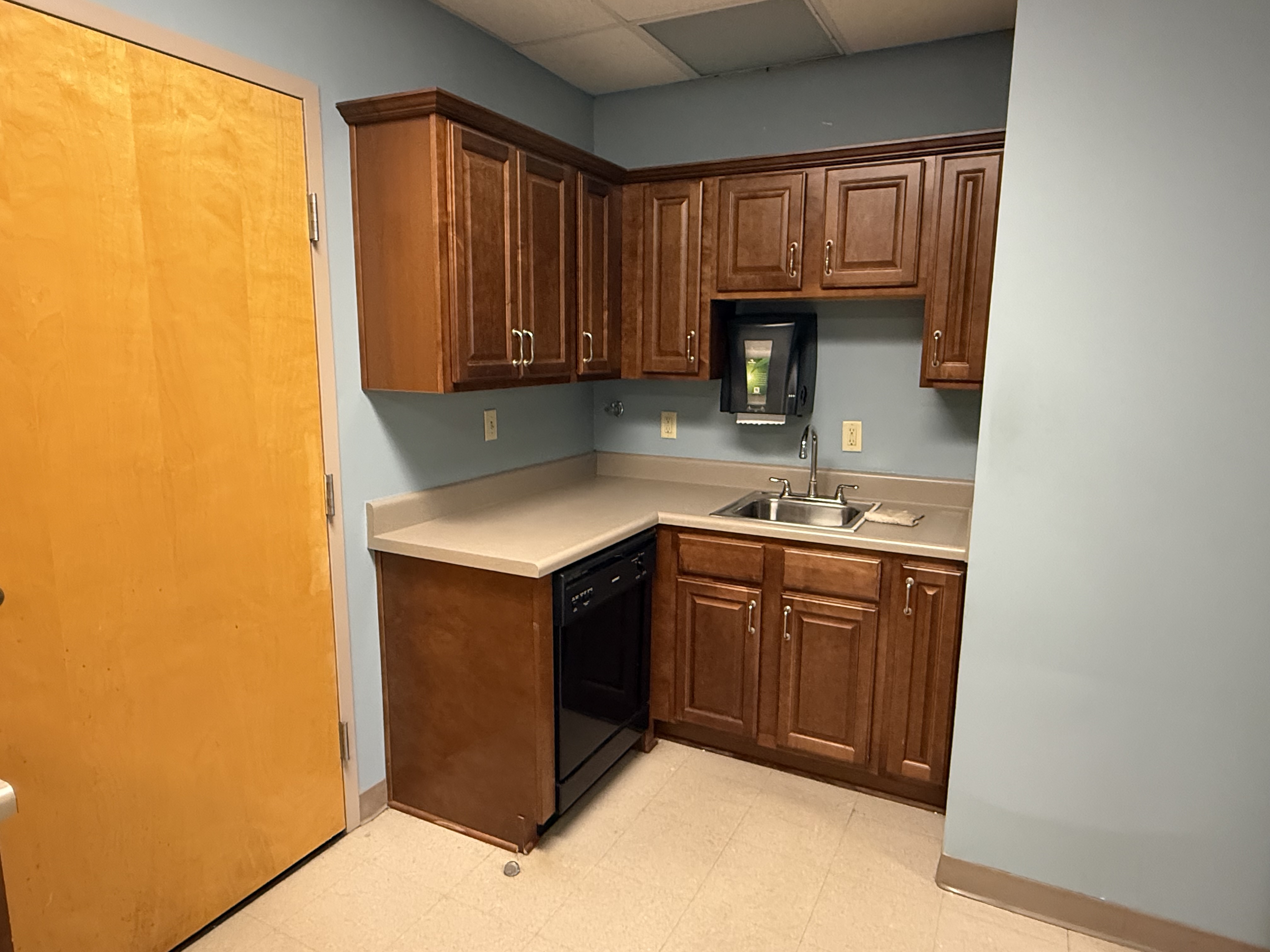 Kitchen and break area with cabinets, counter, and sink