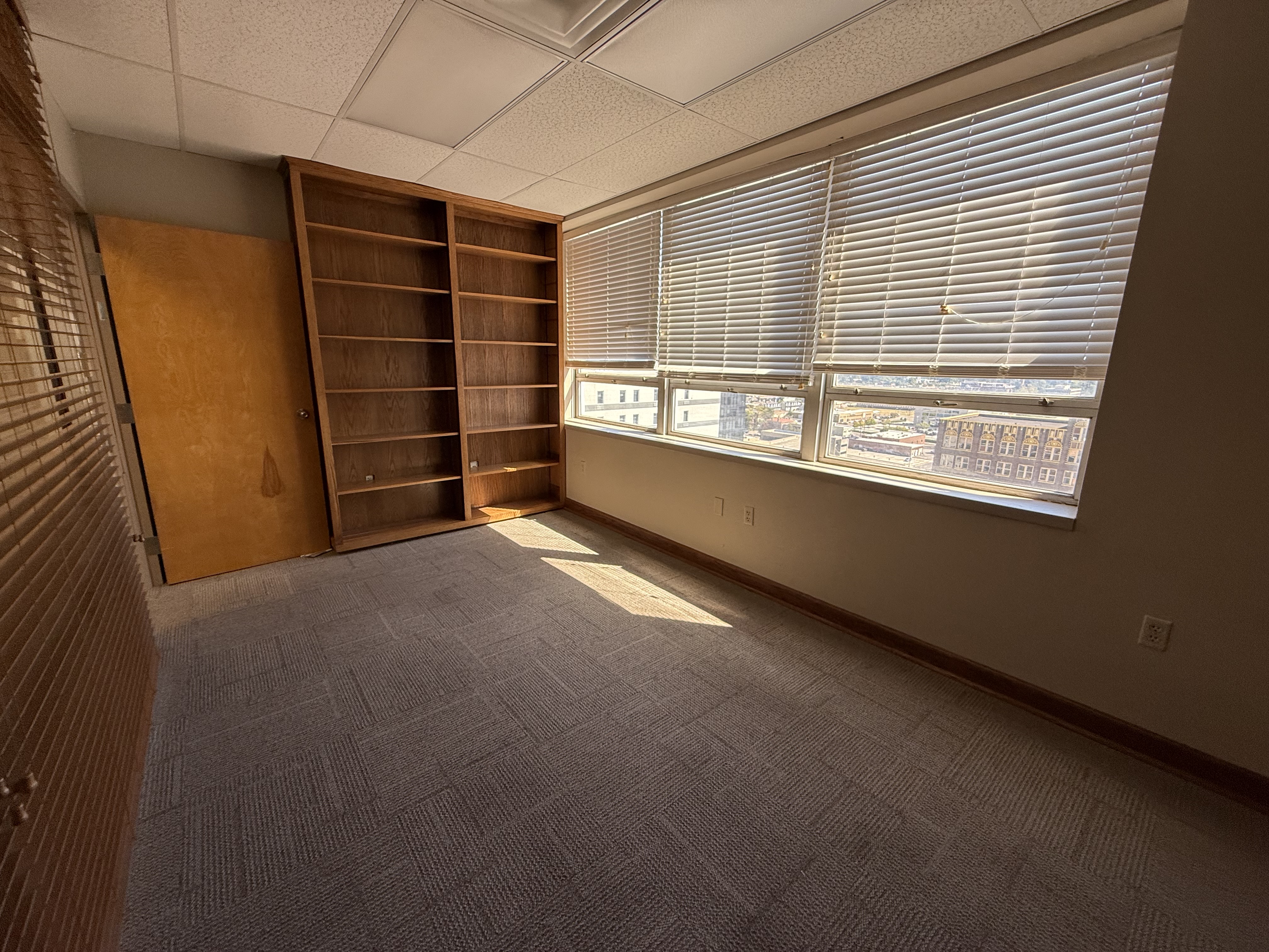 Private office with built-in shelving and downtown views